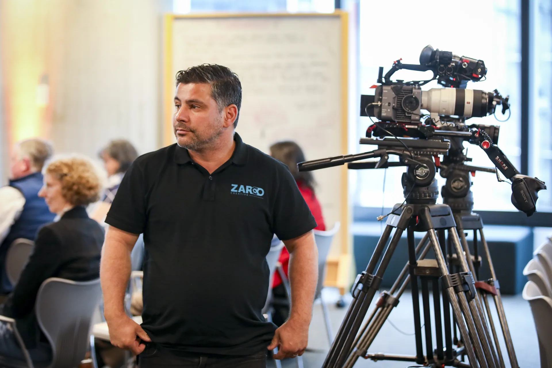 Oscar Vieira from Zarco Creative beside his camera rig at a client event in Sydney