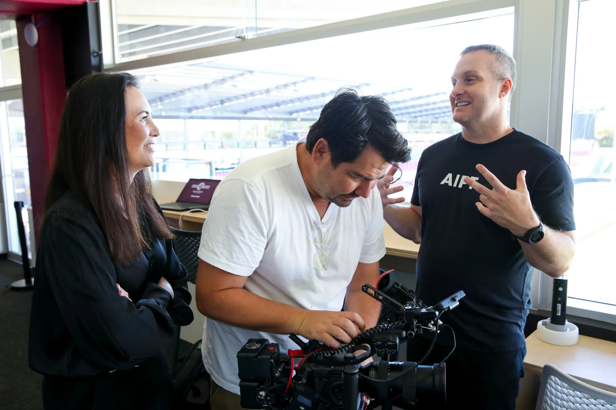 The Zarco Creative crew on location at a stadium shoot, talking through the setup