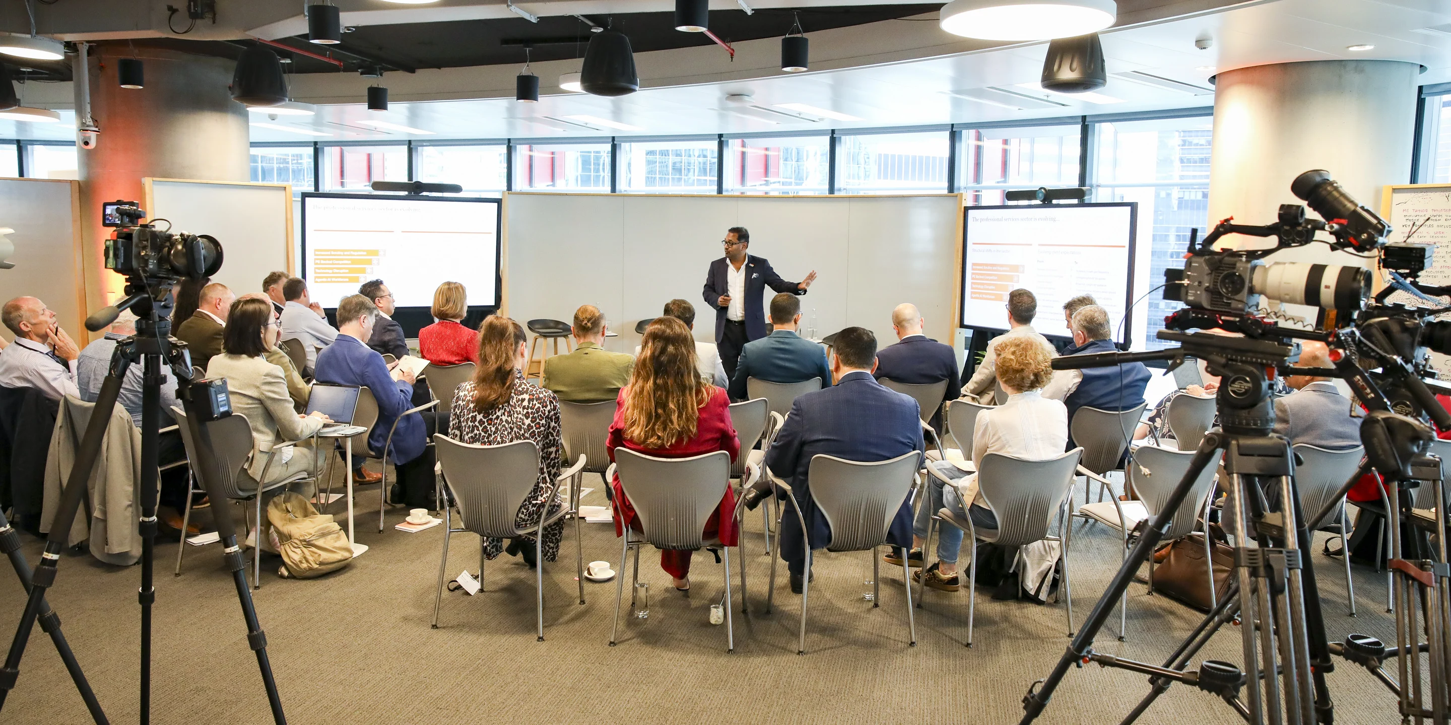 A Zarco Creative crew filming a presenter and a full room at a PwC session in Sydney, two cinema cameras on tripods
