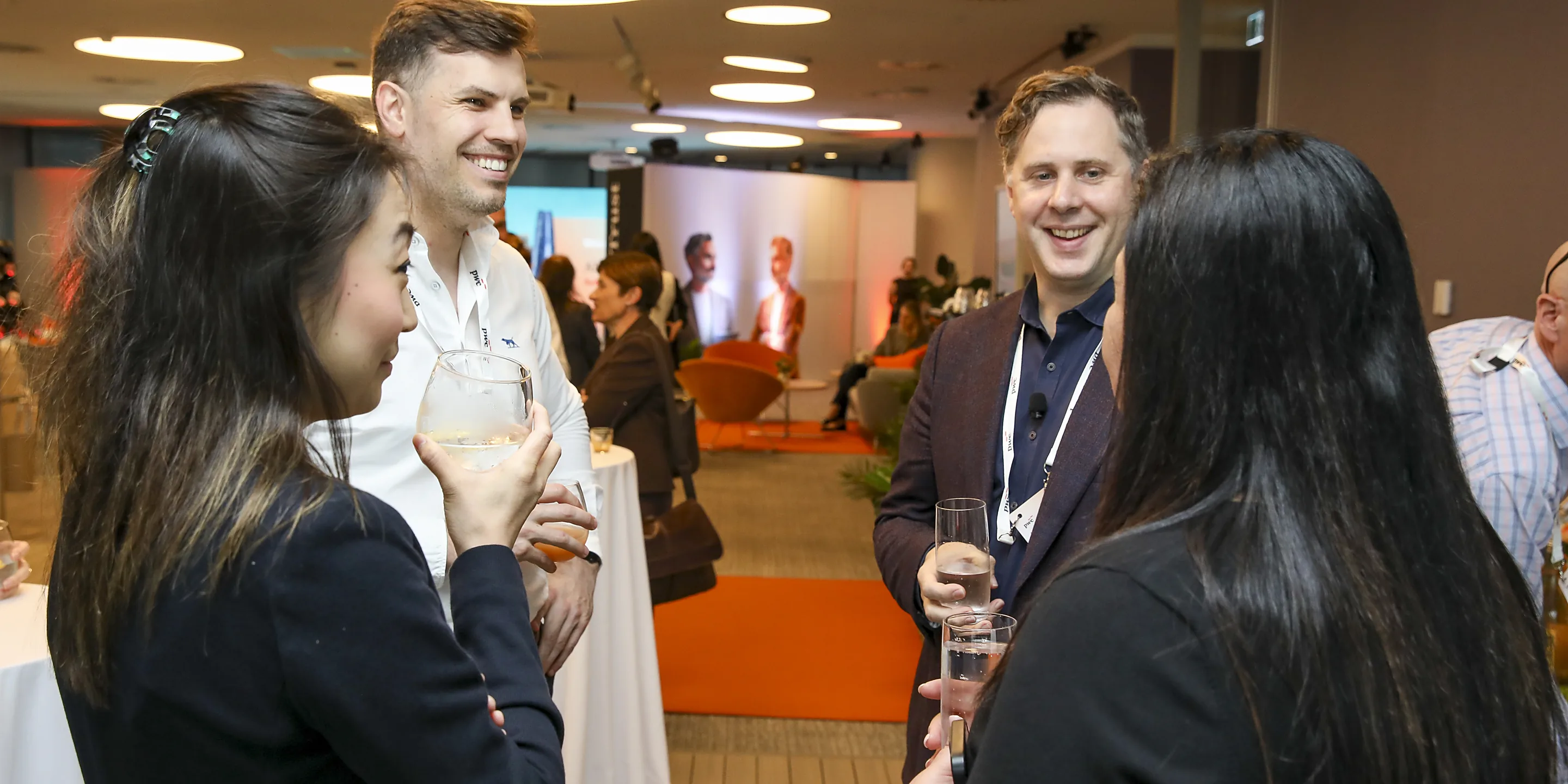 Guests laughing over drinks at PwC's AI Leadership Experience in Sydney, filmed by Zarco Creative