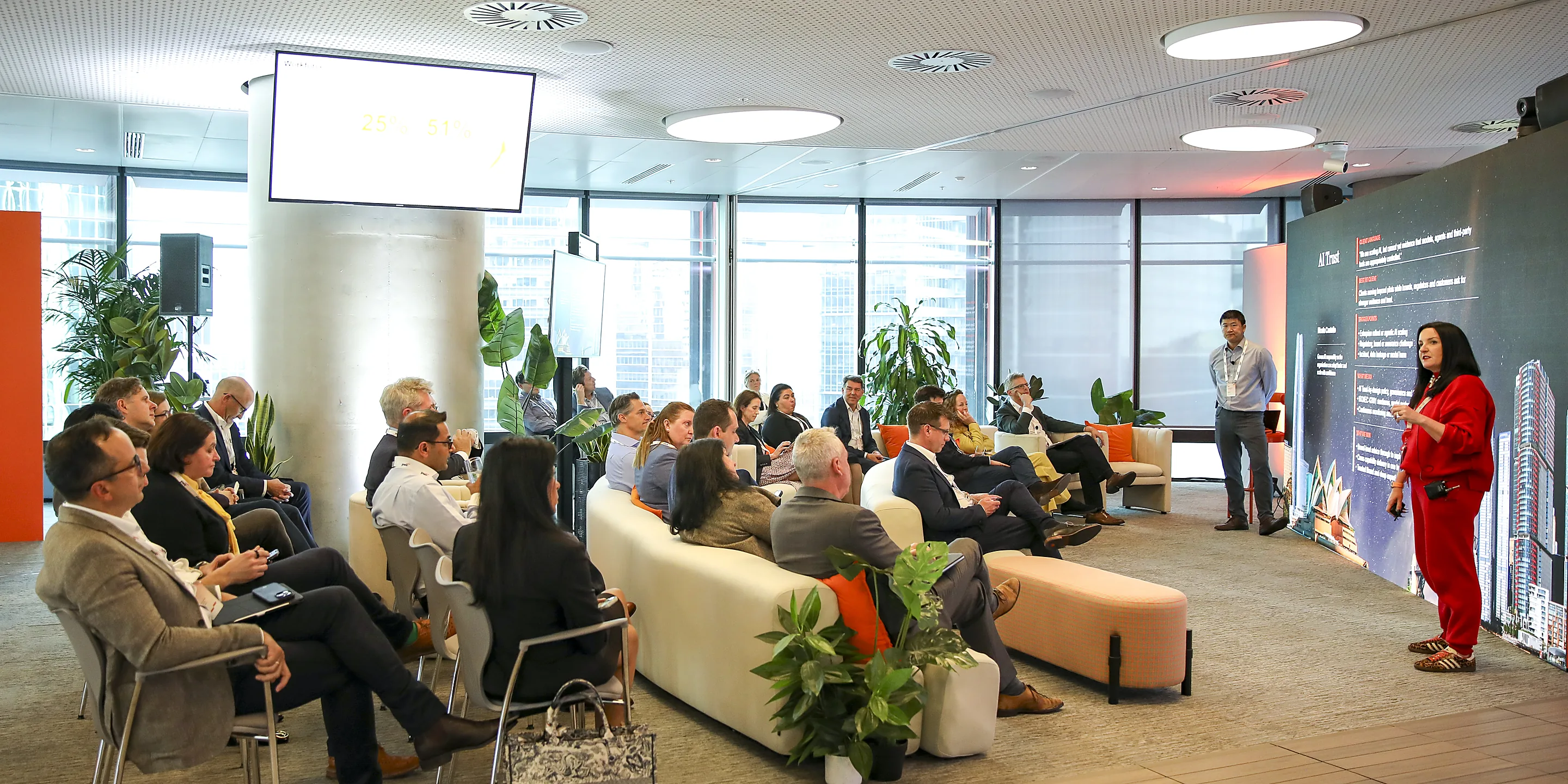 A speaker presenting to a seated audience at PwC's AI Leadership Experience in Sydney, filmed by Zarco Creative