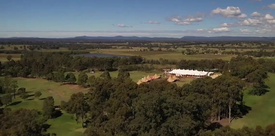 Wide aerial of the Hunter Valley with The Outside marquees among the trees