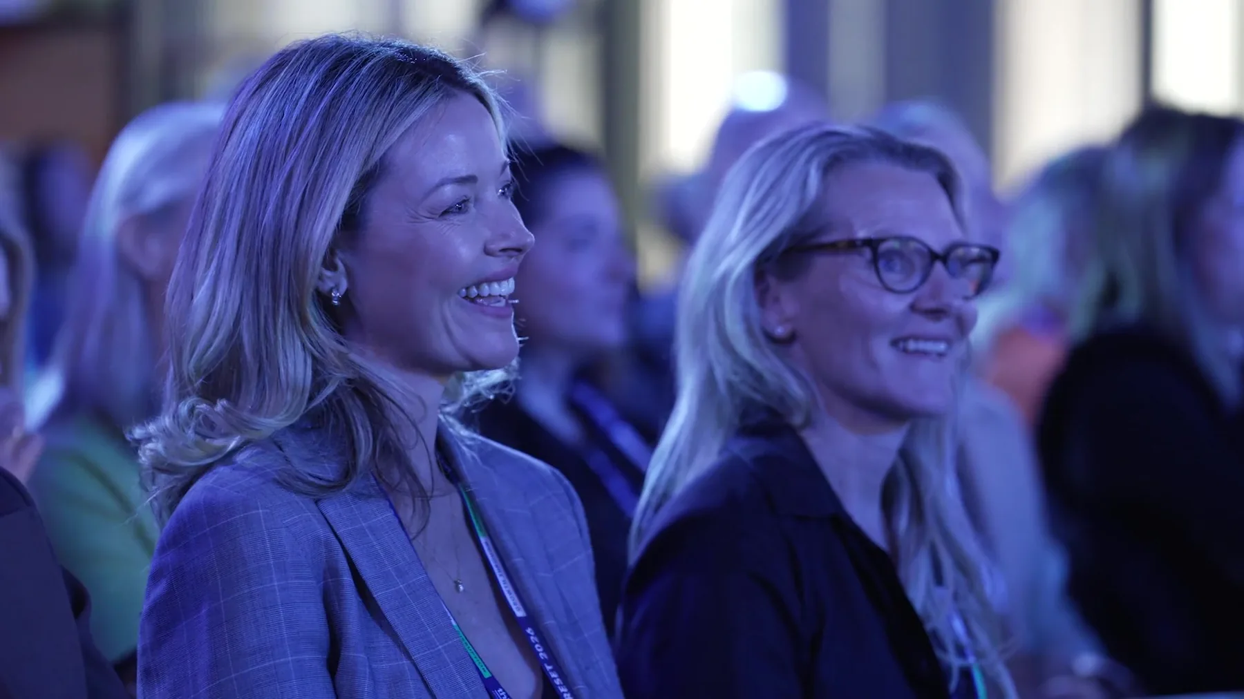 Two delegates smiling at the stage at RESET 2026 in Sydney, filmed by Zarco Creative