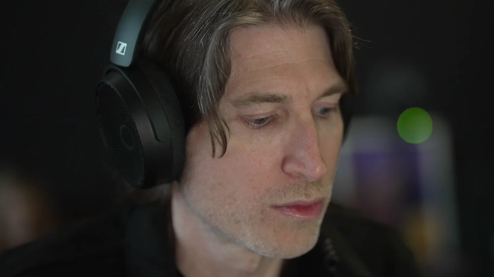 Eric J in Sennheiser headphones, working in his studio