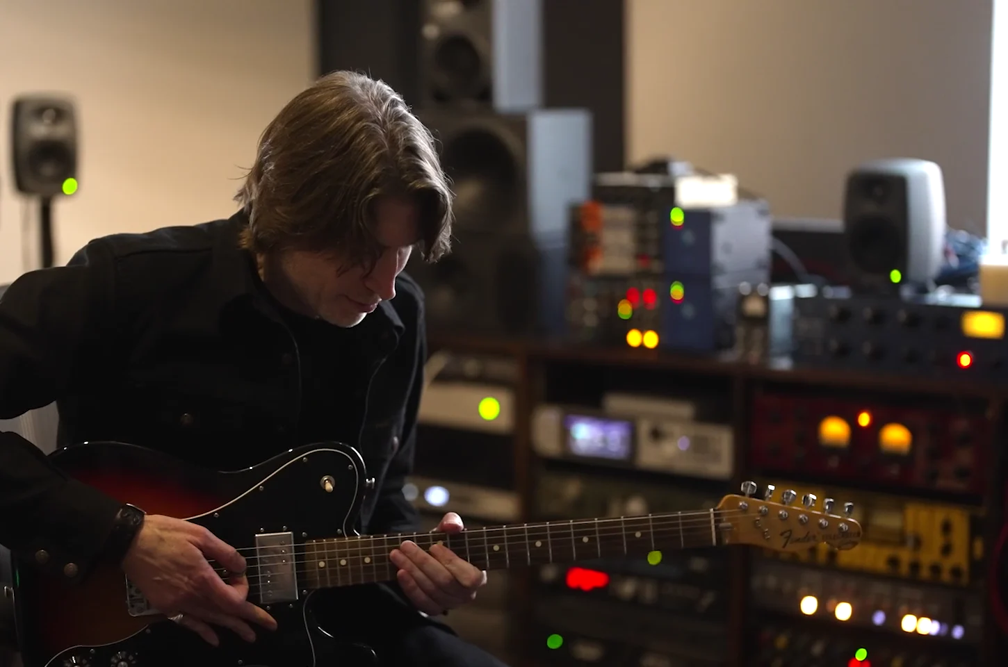 Producer Eric J playing guitar in his studio, from Who Is Eric J, made with Sennheiser and Neumann