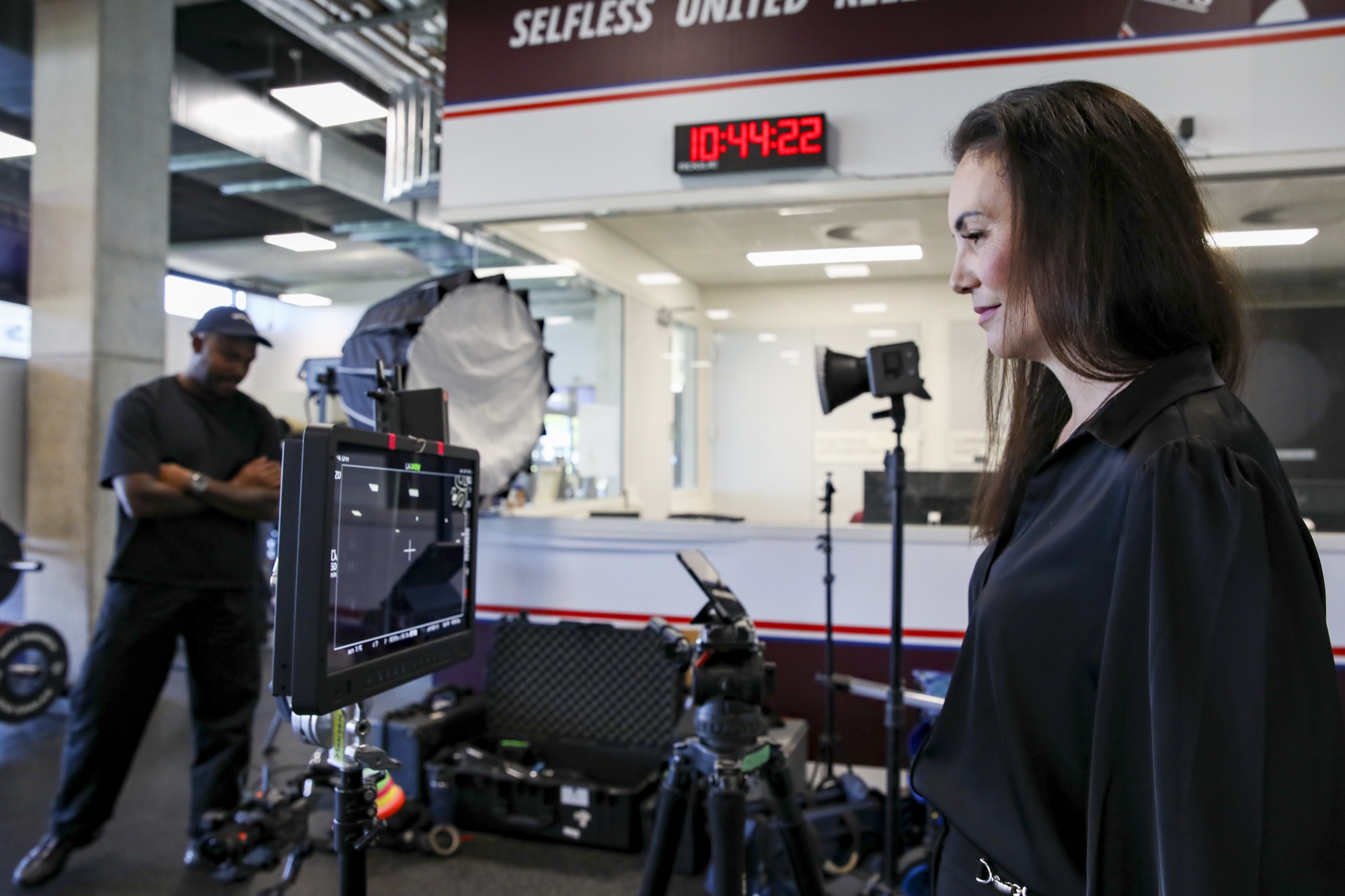 A leader on a lit Zarco Creative set in her own workplace, ready to film