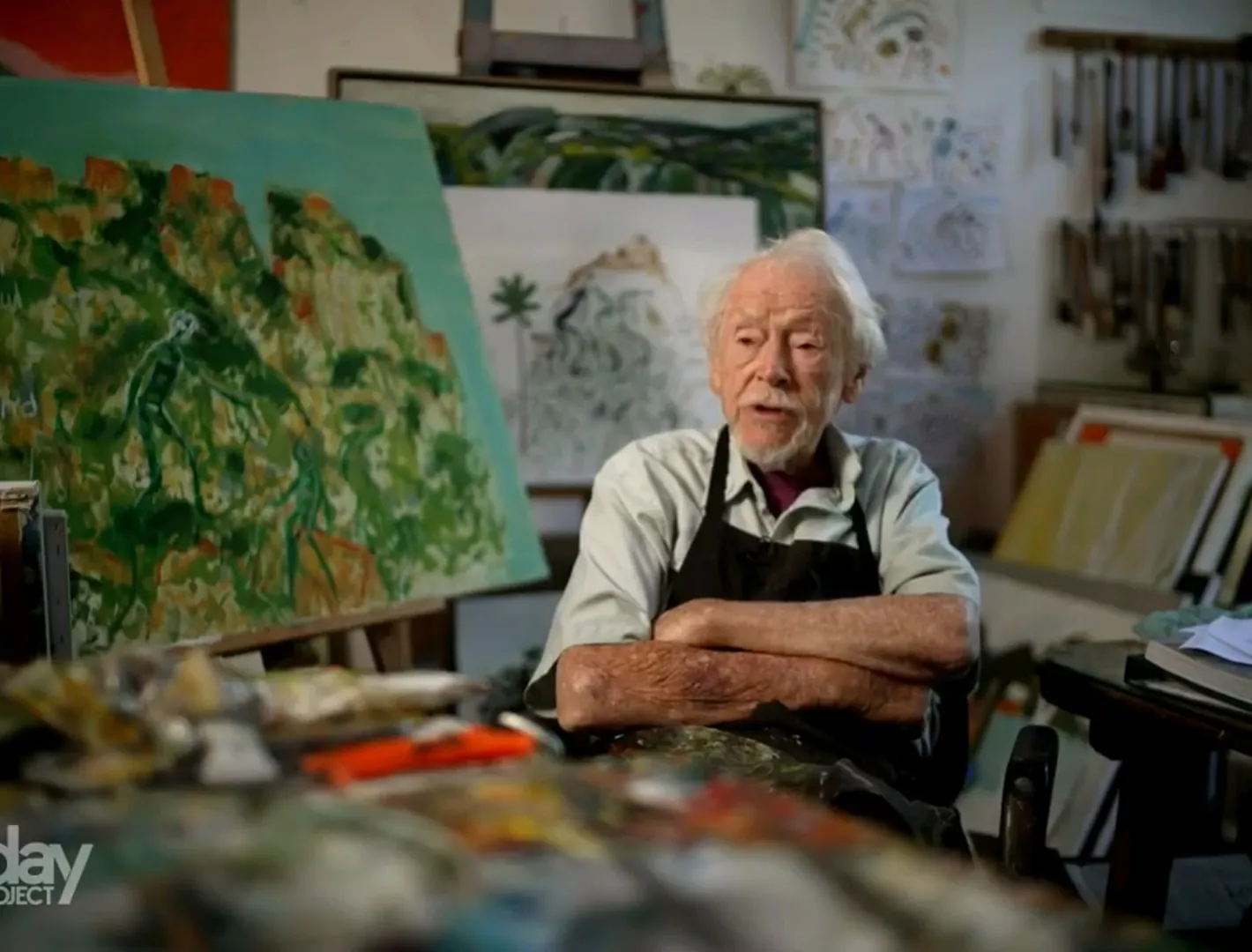 Guy Warren drawing at his desk, filmed by Zarco Creative