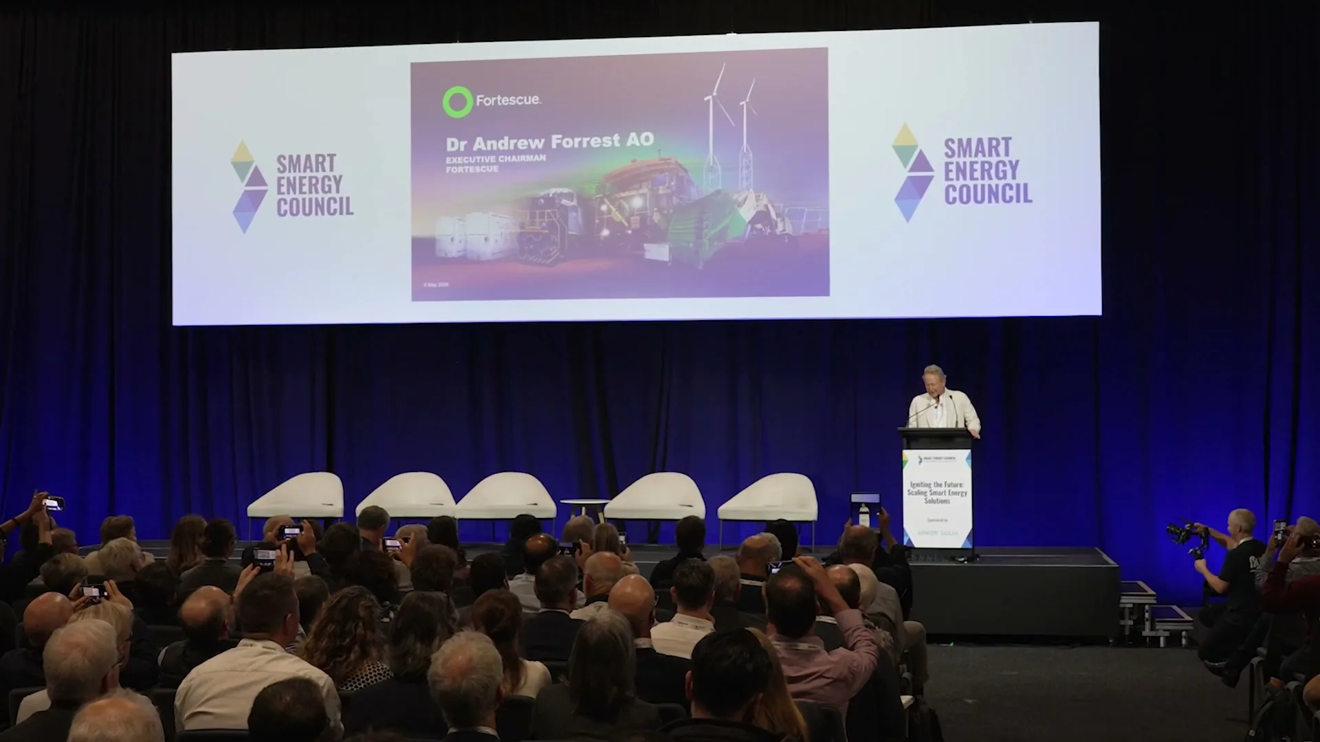 Dr Andrew Forrest AO at the lectern on the Smart Energy Council stage, filmed by Zarco Creative