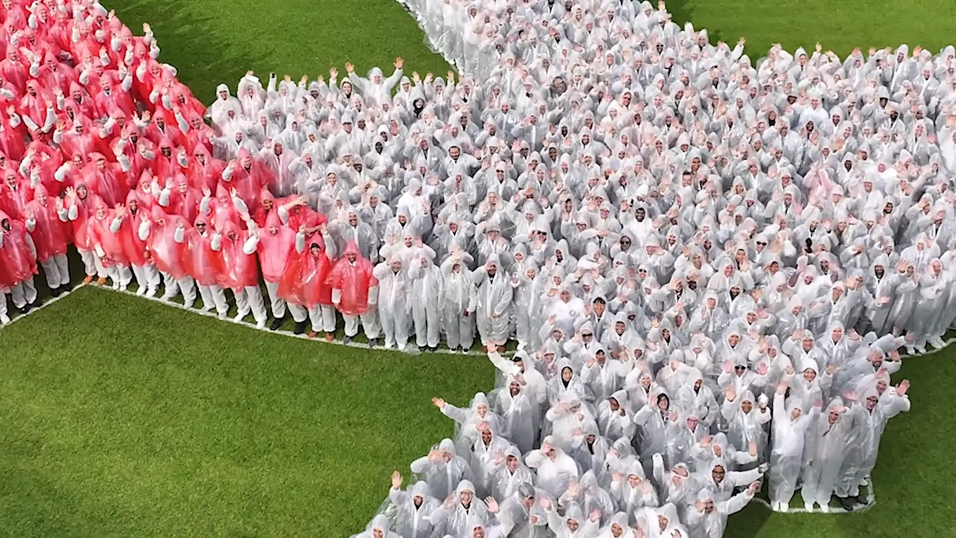 Qantas Loyalty staff in red and white ponchos forming a giant star on the track at Royal Randwick, filmed from the air by Zarco Creative